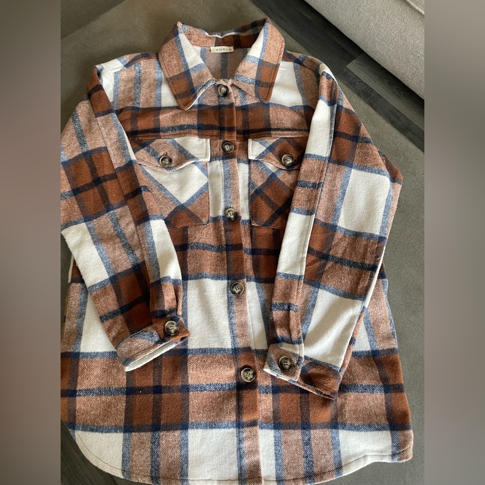 Kori plaid brown with neutral colors jacket.